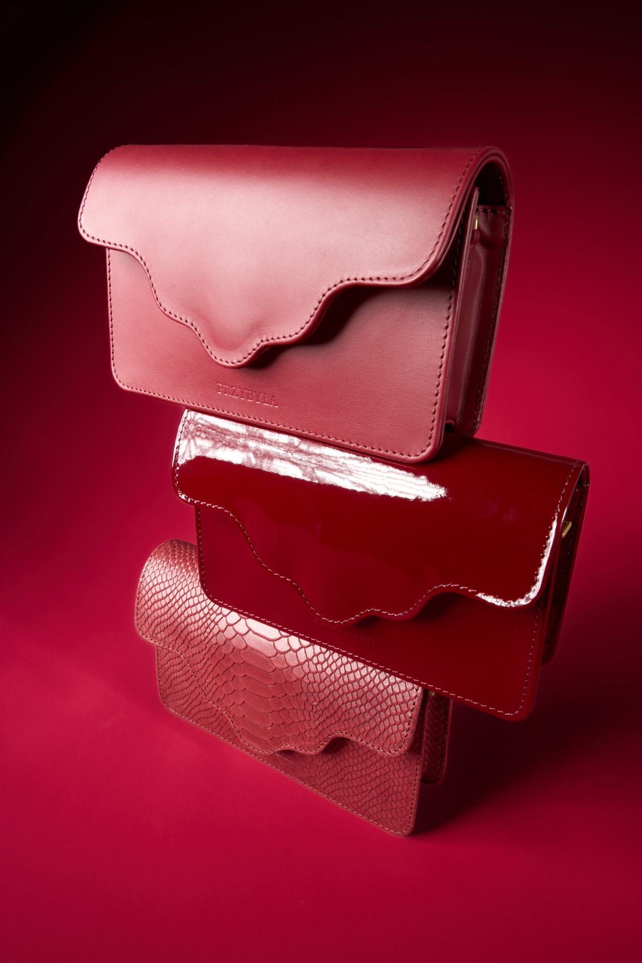 Stacked red bags, three textures