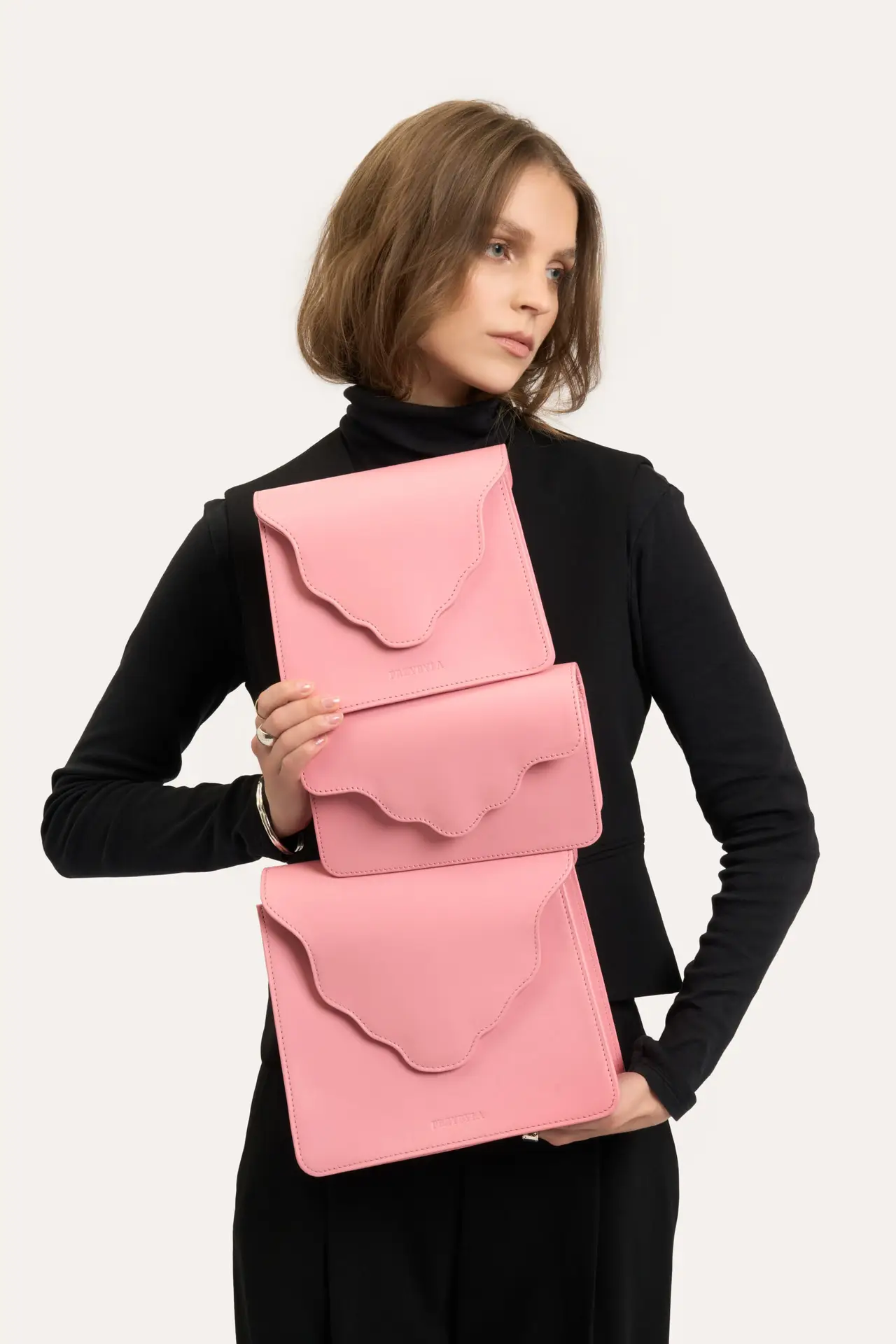 Three pink scalloped clutches
